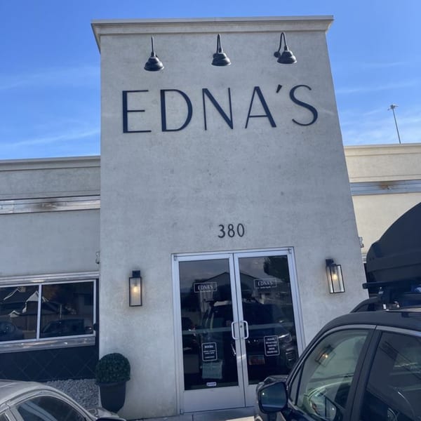 The exterior of Ednas Market & Grille, a New American restaurant, with its name prominently displayed.